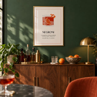 Negroni Cocktail Poster, framed on the wall of a stylish home bar with a deep green wall in a living room