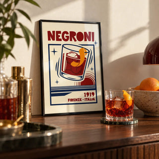 Negroni Cocktail Print, a small A4 framed print leaning on a shelf in a living room