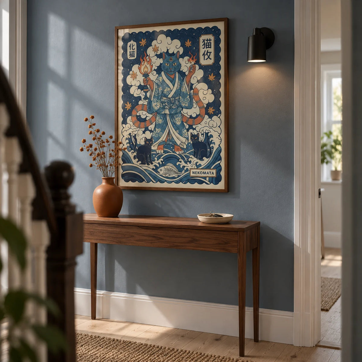 Nekomata Art, framed on the wall of a narrow hallway in a renovated UK terrace with a muted blue wall and pale timber floor