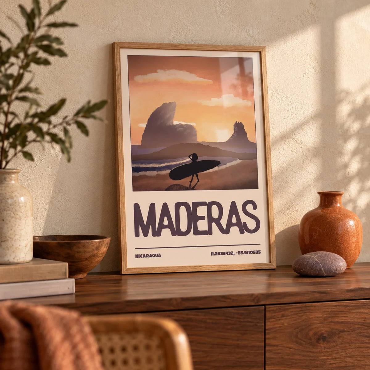 Nicaragua Surfer Wall Art, a small A4 framed print leaning on a walnut sideboard in a living room
