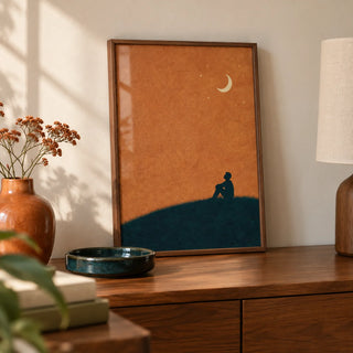 Night Silhouette Poster, a small A4 framed print leaning on a walnut sideboard in a living room