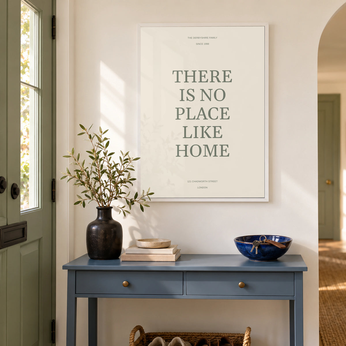 No Place Like Home in a bright entrance hallway, white frame