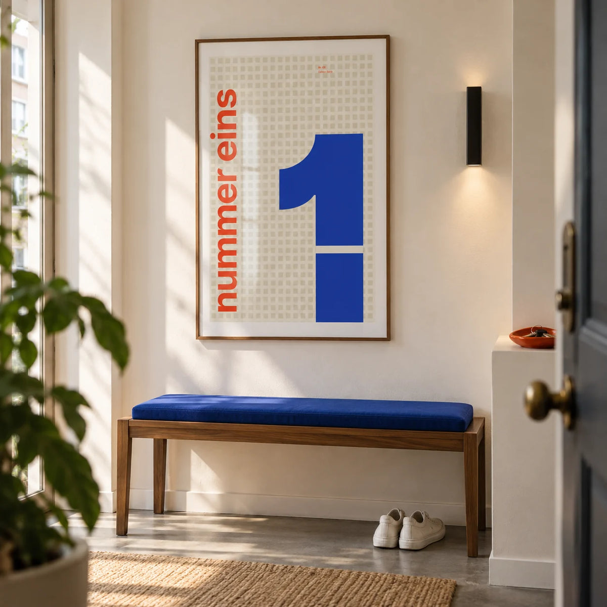 Number 1 Print, framed on the wall of a bright entrance hallway in a city flat with a warm white wall and grey concrete floor
