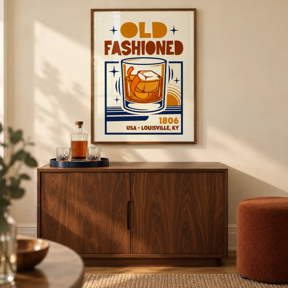 Old Fashioned Art Print, framed on the wall of a compact home bar in a design-led UK flat with a warm cream wall and walnut cabinetry in a living room