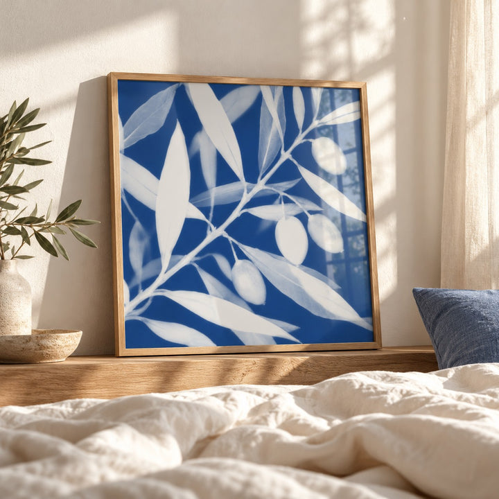 Olive Branch Cyanotype Print styled leaning by a bed (frame not included)