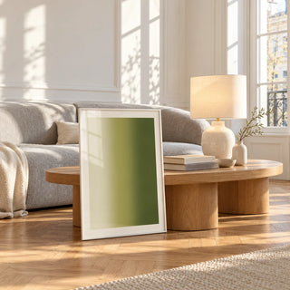 Olive Green Abstract Wall Art, framed and leaning against a coffee table in a bright living room