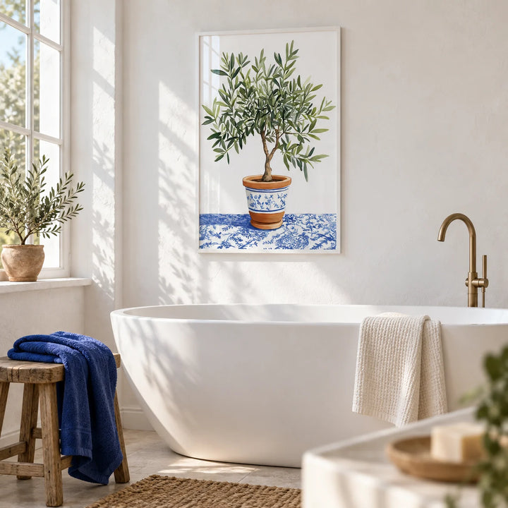 Olive Tree Art Print, framed on the wall of a bright white bathroom with a plaster wall