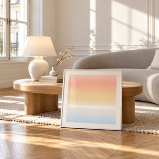 Ombre Print, framed and leaning against a coffee table in a bright living room