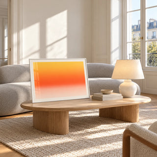 Orange Abstract Wall Art, framed and leaning against a coffee table in a bright living room