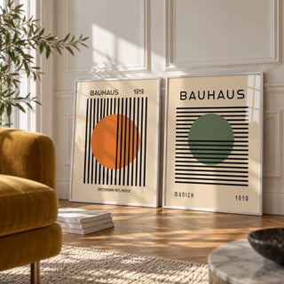 Orange and Green Wall Art Set of 2 styled against a white panelled wall behind a mustard velvet armchair: Striped Sun and Modern Orb shown framed side by side (frames not included)