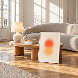 Orange and Yellow Wall Art, framed and leaning against a coffee table in a bright living room