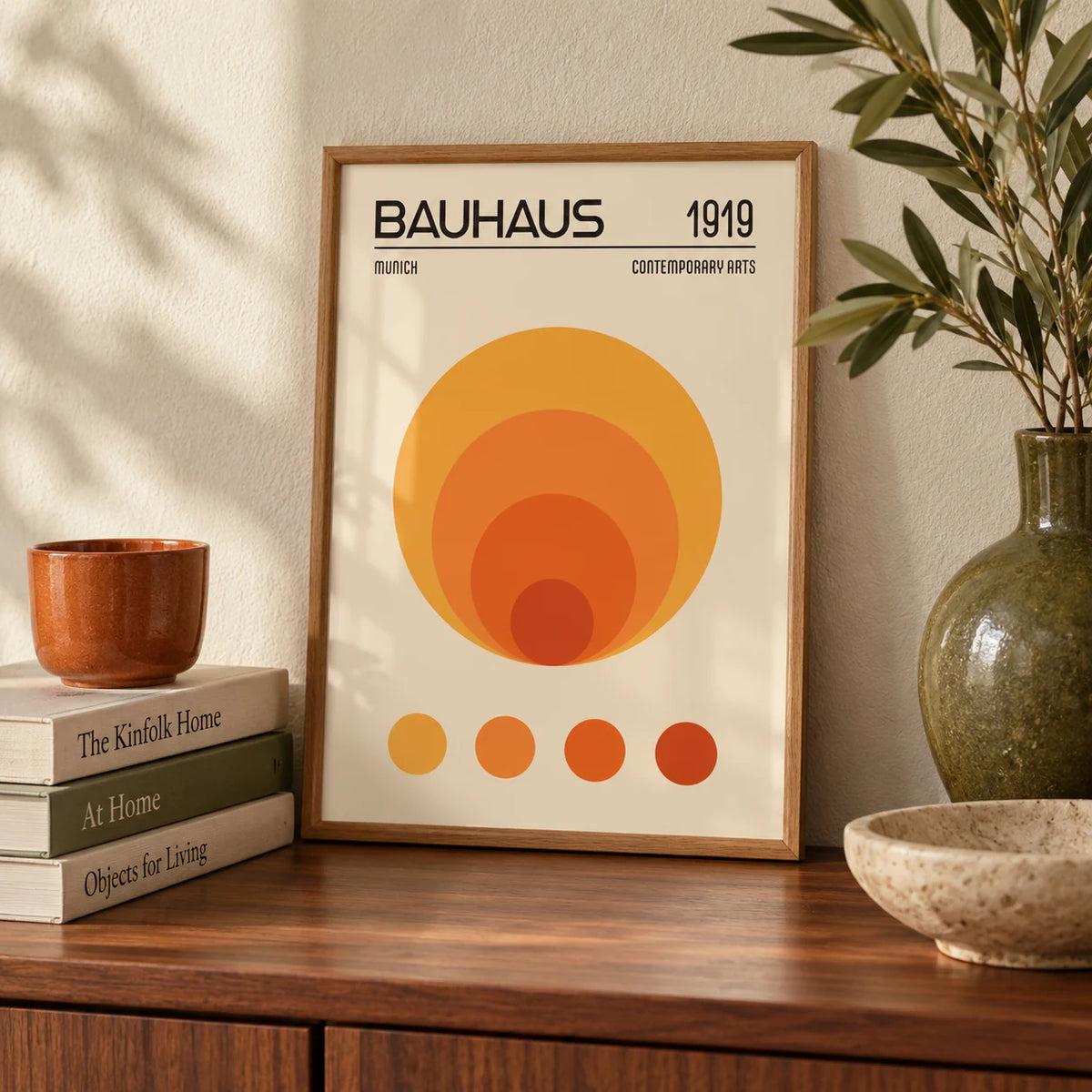 Orange Bauhaus Poster, a small A4 framed print leaning on a walnut sideboard in a living room