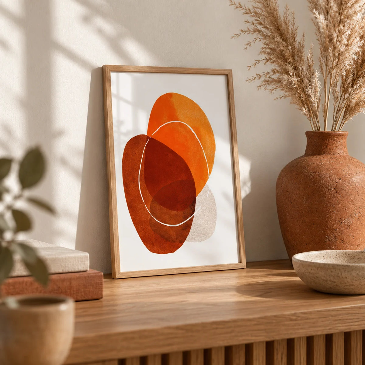 Orange Boho Art Print, a small A4 framed print leaning on an oak shelf in a living room