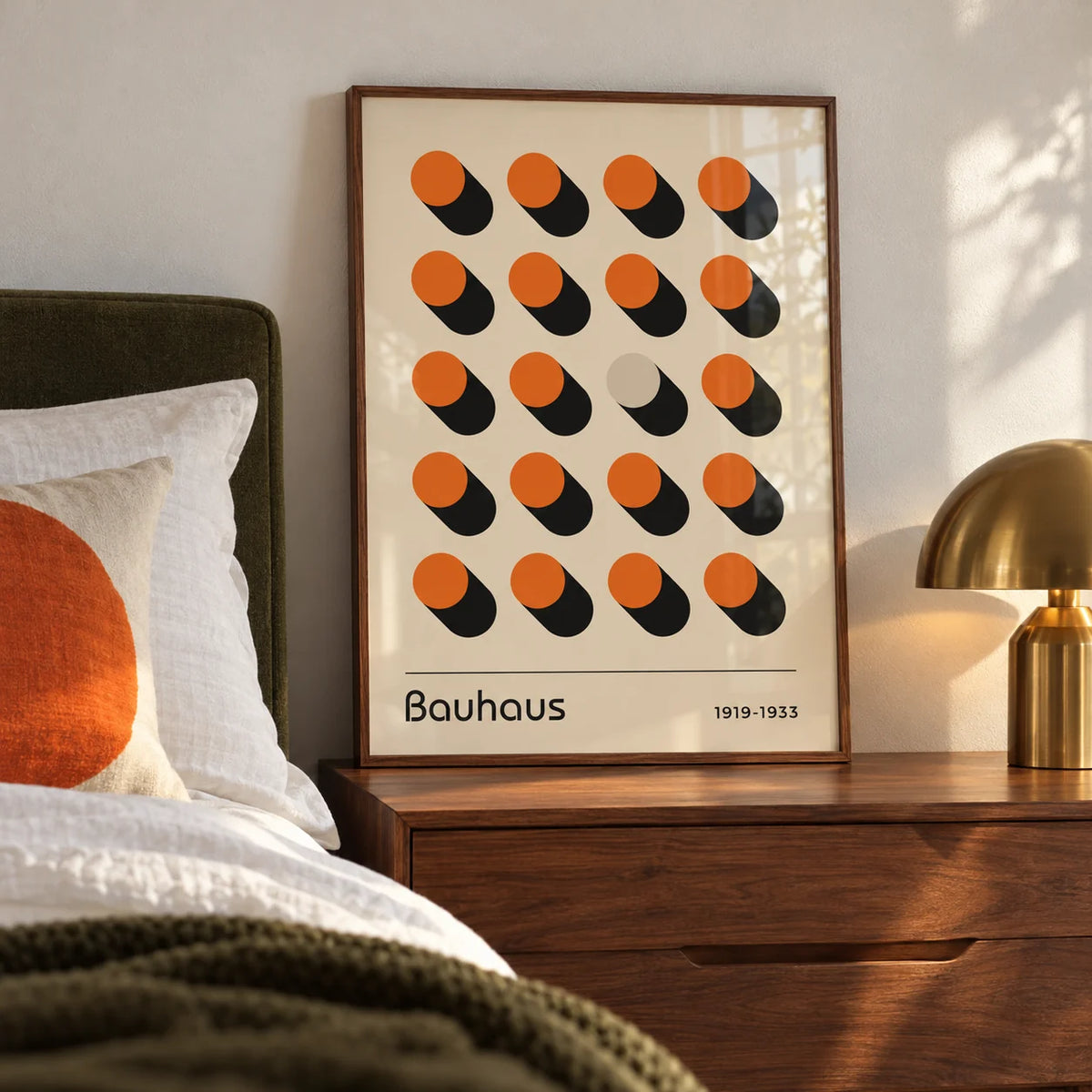 Orange Poster, a framed print leaning on a walnut bedside chest in a calm mid-century bedroom
