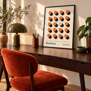 Orange Poster, a framed print leaning on a walnut desk in a mid-century home office