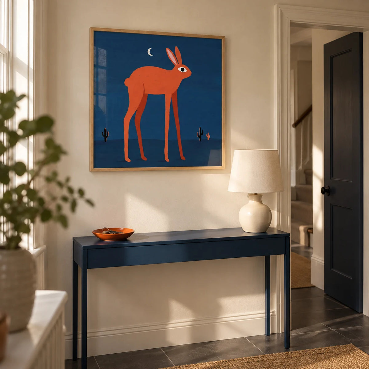 Orange Rabbit Wall Art, framed on the wall of a welcoming hallway in a UK terraced house with cream walls and a plain charcoal tiled floor