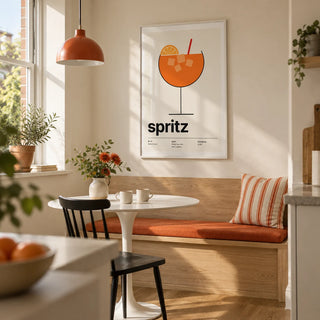 Orange Spritz Print, framed on the wall of a bright kitchen breakfast nook in a compact UK terrace with a soft cream wall and a built-in pale oak bench