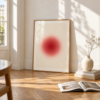 Orb Print, framed and leaning on the parquet floor of a bright living room