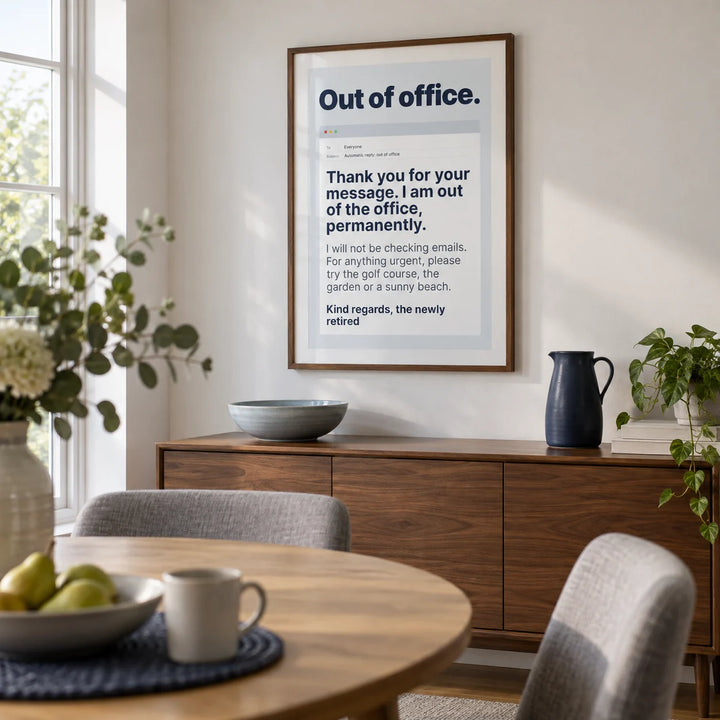 Out of Office Print, framed on the wall of a contemporary dining room in a UK family home with a white wall and a round oak dining table