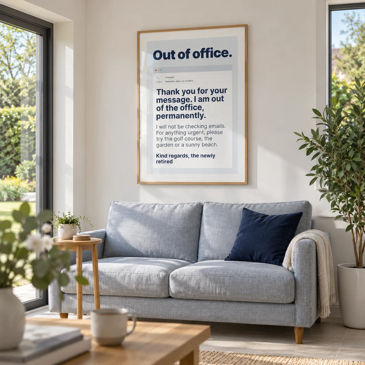 Out of Office Print, framed on the wall of a modern garden room in a UK bungalow with white plaster walls and broad windows overlooking a leafy garden in a living room