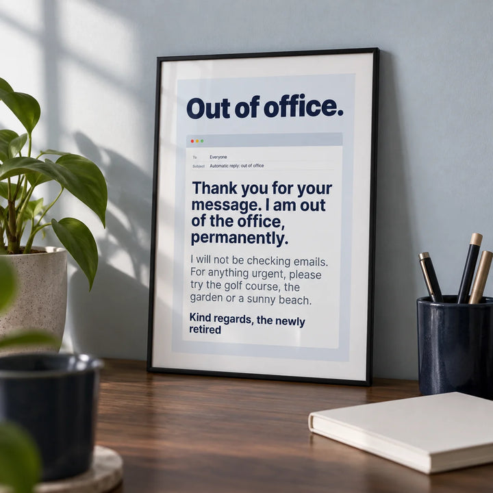 Out of Office Print, a small A4 framed print leaning on a walnut desk