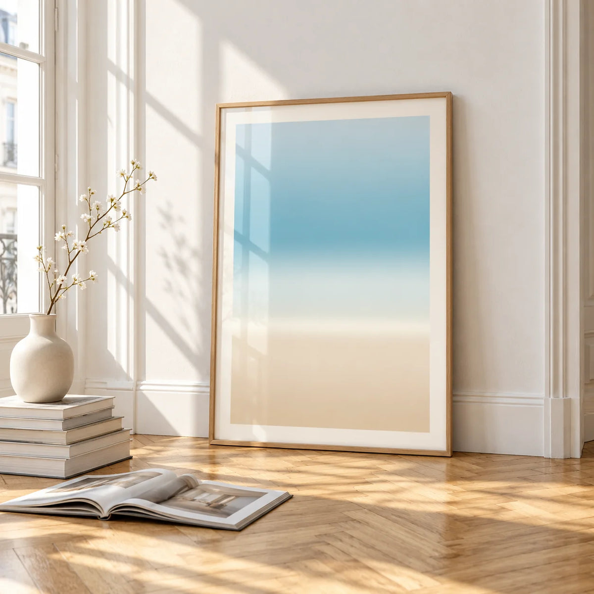 Pale Blue Wall Art, framed and leaning on the parquet floor of a bright living room