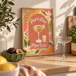 Passion Fruit Martini Poster, a small A4 framed print leaning on a pale oak kitchen worktop