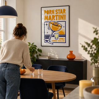 Passion Fruit Martini Print, framed on the wall of a contemporary dining room in a young couple's UK flat with warm white walls