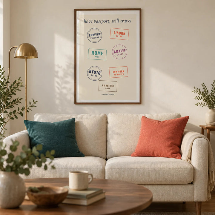 Passport Stamps Poster, framed on the wall of a warm modern living room in a UK retirement flat with an ivory plaster wall and oak floor