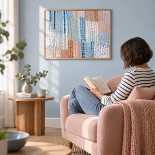 Pastel Blue And Pink Abstract Prints, framed on the wall of a calm reading corner with a pale blue wall in a living room