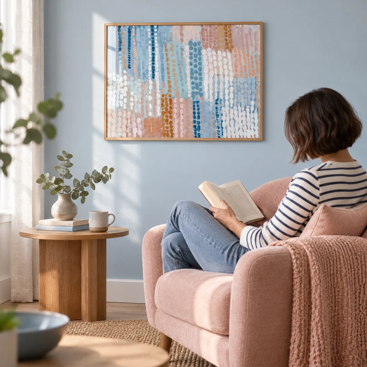 Pastel Blue And Pink Abstract Prints, framed on the wall of a calm reading corner with a pale blue wall in a living room