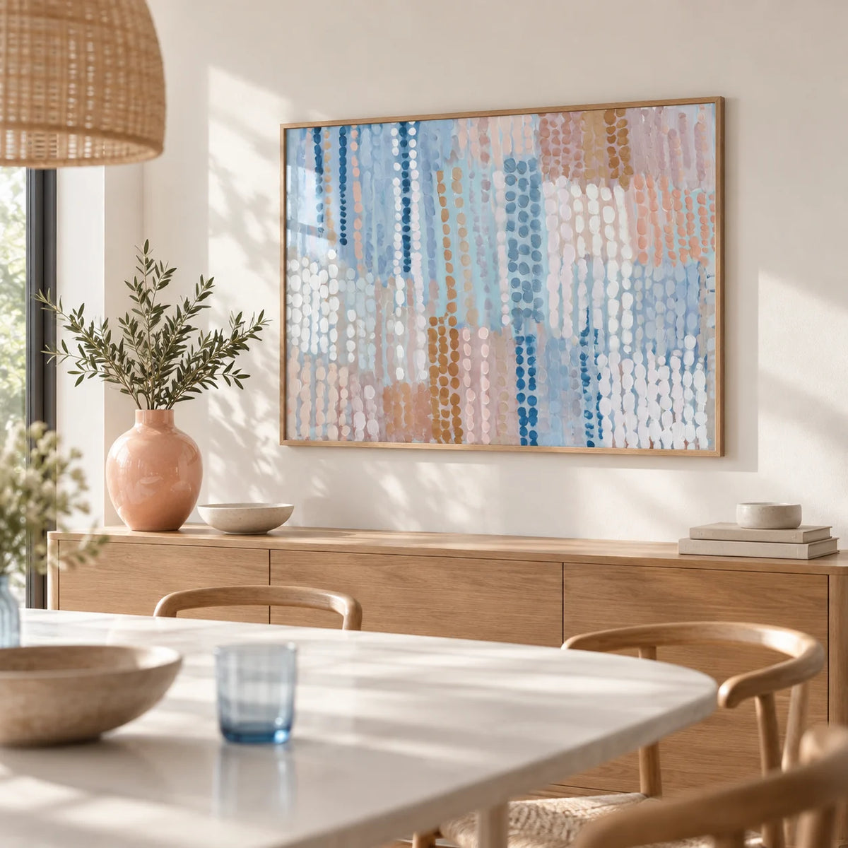 Pastel Blue And Pink Abstract Prints, framed on the wall of a light dining room with a soft white wall