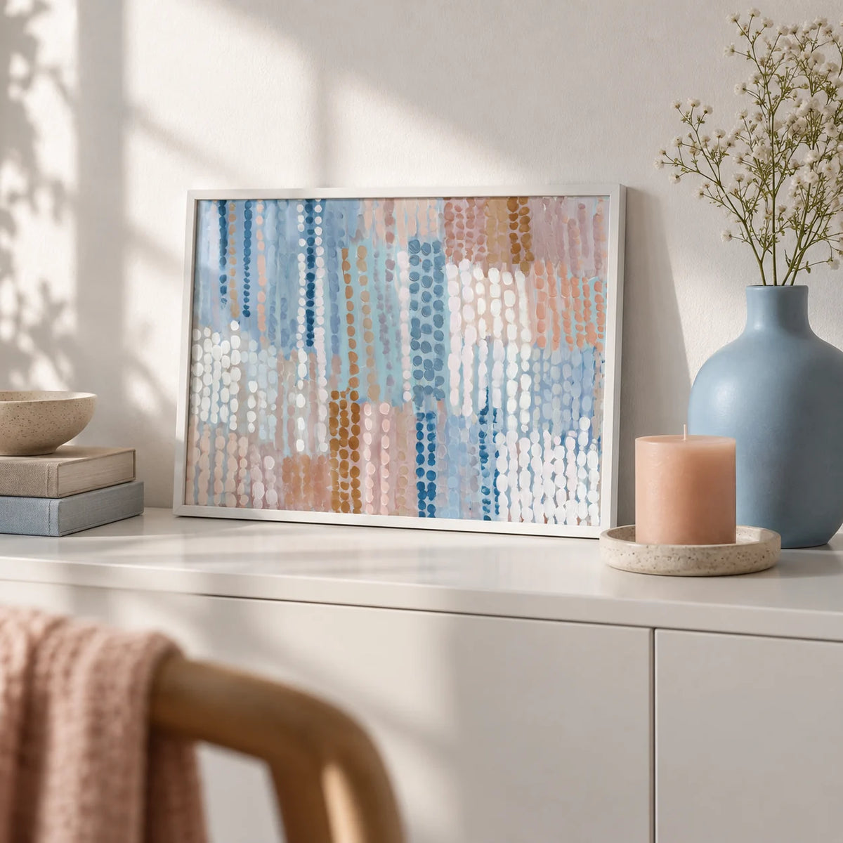 Pastel Blue And Pink Abstract Prints, a small A4 framed print leaning on a white sideboard in a living room