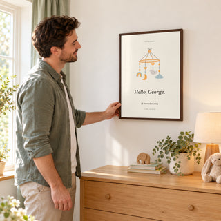 Baby Nursery Poster in a parent arranging the nursery, dark wood frame