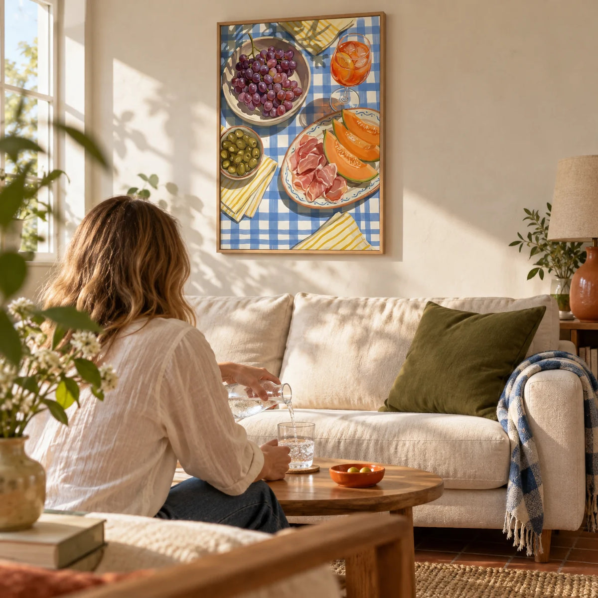Picnic Decor Wall Art, framed on the wall of a sunny living room in a UK flat with pale plaster walls and a terracotta floor