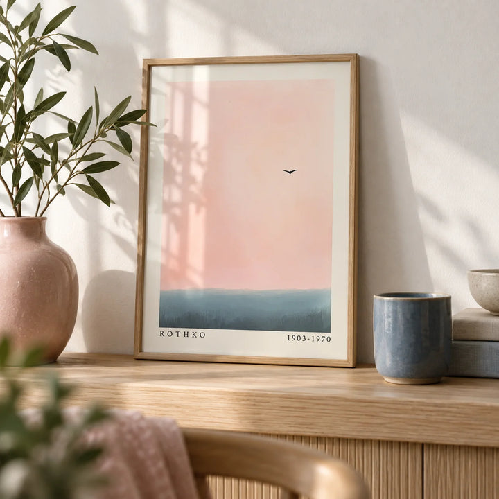 Pink and Blue Wall Art, a small A4 framed print leaning on a pale oak shelf in a living room