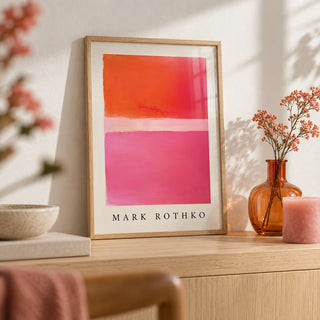 Pink and Orange Wall Art, a small A4 framed print leaning on a pale oak shelf in a living room