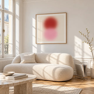 Pink and Red Print, framed on the wall of a bright living room corner