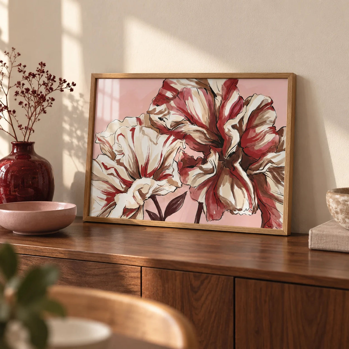 Pink Background Flower Print, a small A4 framed print leaning on a walnut sideboard in a living room