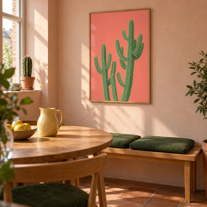 Pink Cactus Painting, framed on the wall of a sunny modern dining room in a compact UK home with pale peach plaster walls and plain terracotta floor tiles
