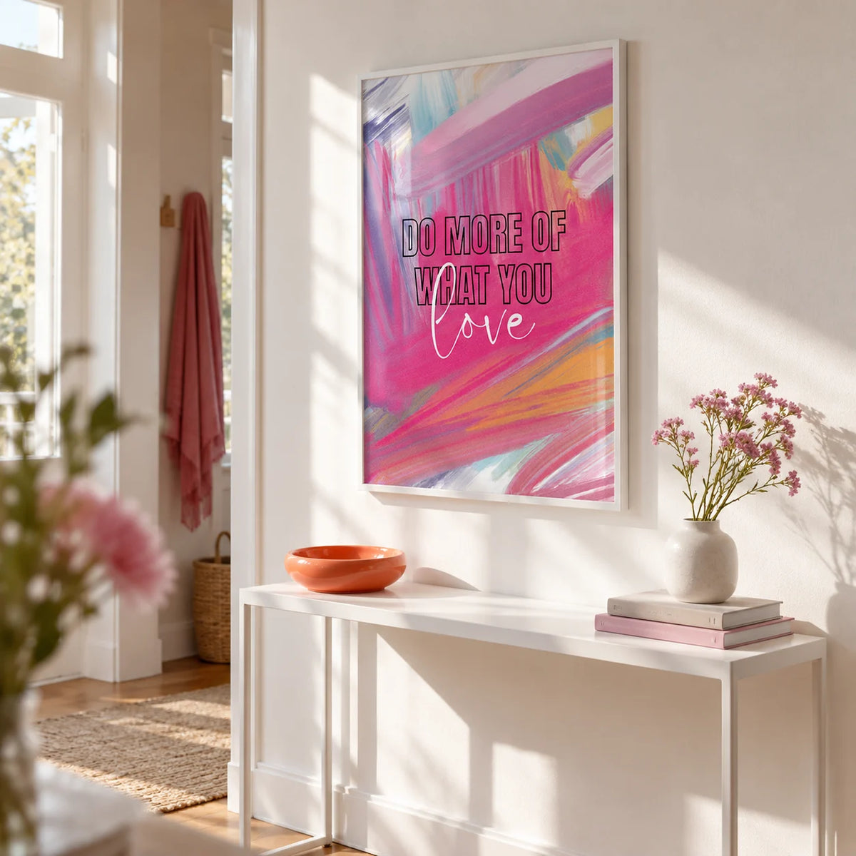 Pink Motivational Posters, framed on the wall of a bright first-flat hallway with a white wall