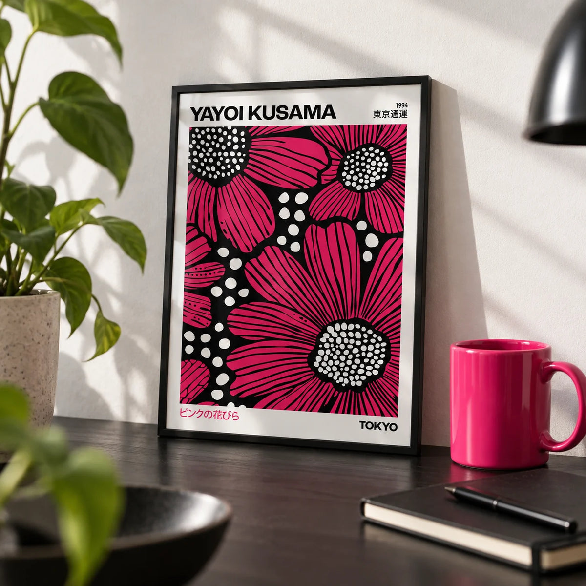 Pink Posters, a small A4 framed print leaning on a black desk
