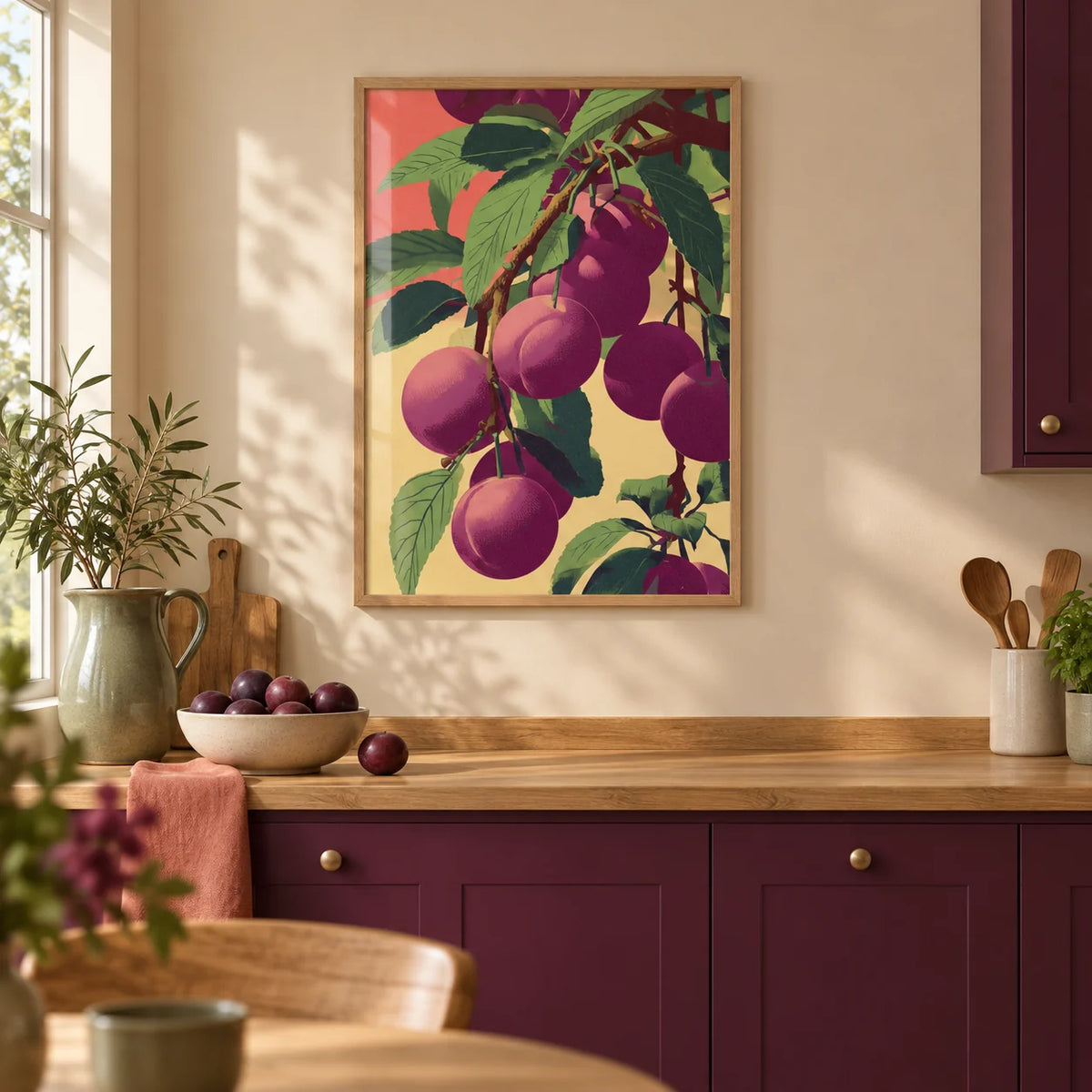 Plum Poster, framed on the wall of a warm modern kitchen with a beige wall and solid plum painted cabinets
