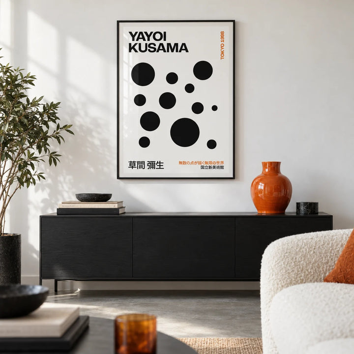 Polka Dots Yayoi Kusama, framed on the wall of a crisp design-led living room in a city flat with a white wall and a polished concrete floor