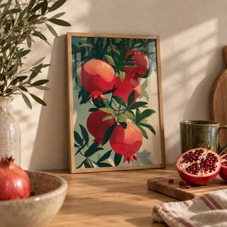 Pomegranate Art Print, a small A4 framed print leaning on an oak worktop in a kitchen