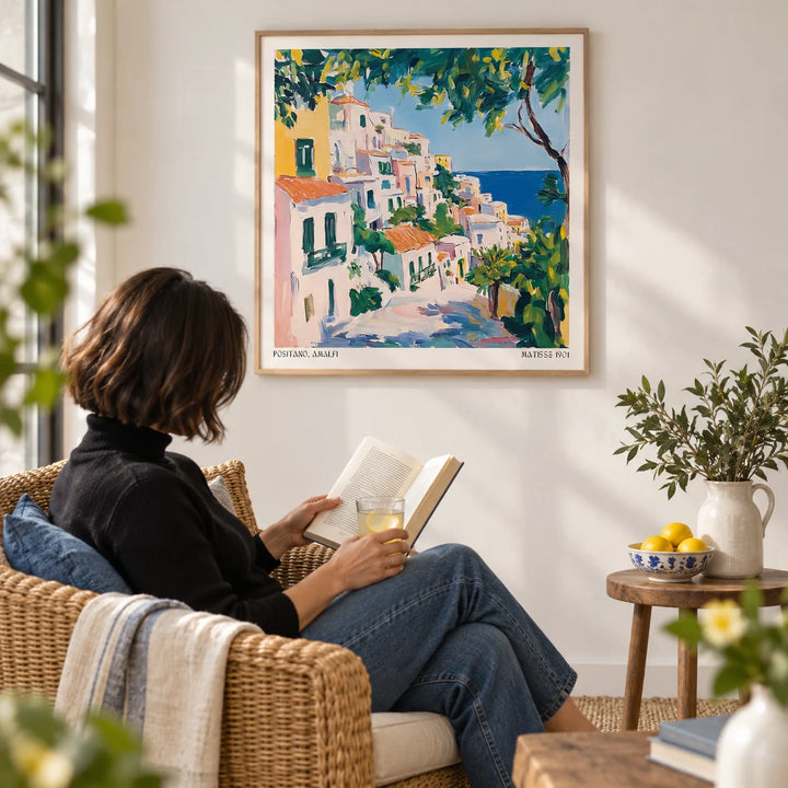 Positano Art, framed on the wall of a breezy reading corner with a white wall in a living room