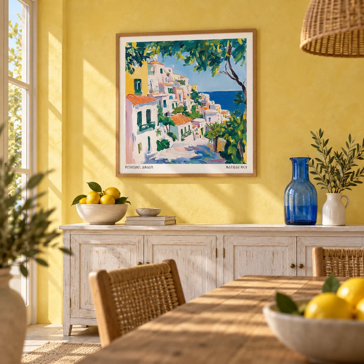 Positano Art, framed on the wall of a sunny dining room with a lemon yellow limewash wall