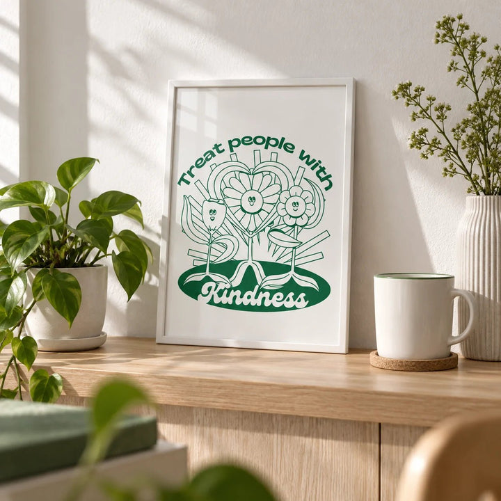 Positive Poster, a small A4 framed print leaning on a pale oak shelf in a living room