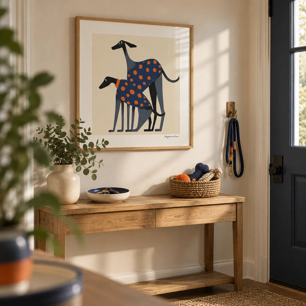 Poster of a Dog, framed on the wall of a hallway by the front door