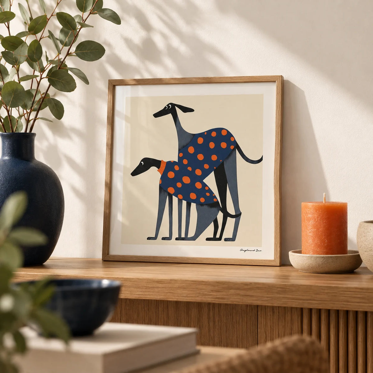 Poster of a Dog, a small A4 framed print leaning on an oak shelf in a living room